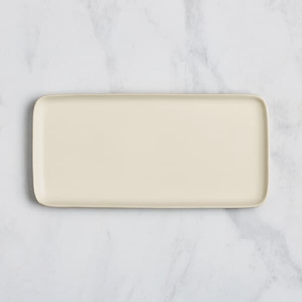 A rectangular white porcelain platter with a white border.