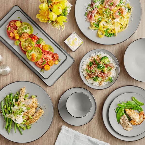 An Acopa Apollo rectangular melamine tray with food on a table.