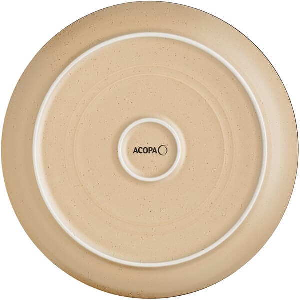 A close up of an Acopa Harvest Tan matte stoneware plate with a small circular design and a white rim.