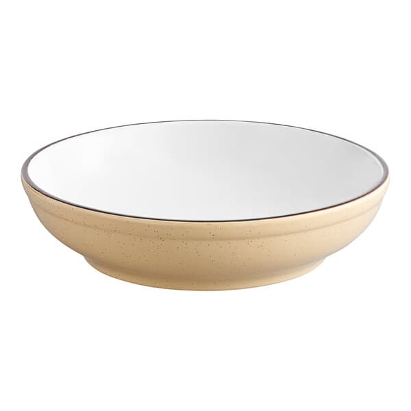 A white stoneware bowl with a tan rim.