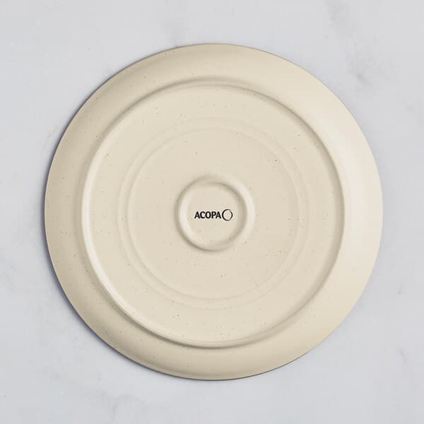An Acopa Embers cream white stoneware plate with a circular design in the center.
