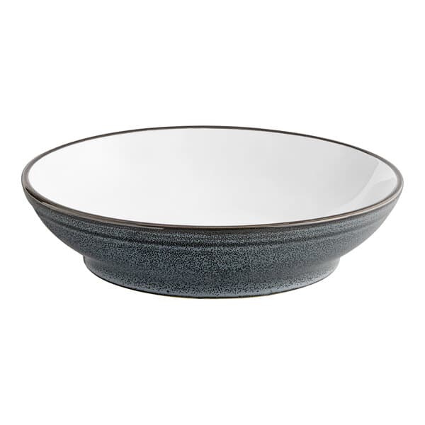 A close-up of an Acopa Midnight Blue Matte Pasta Bowl with a white rim.