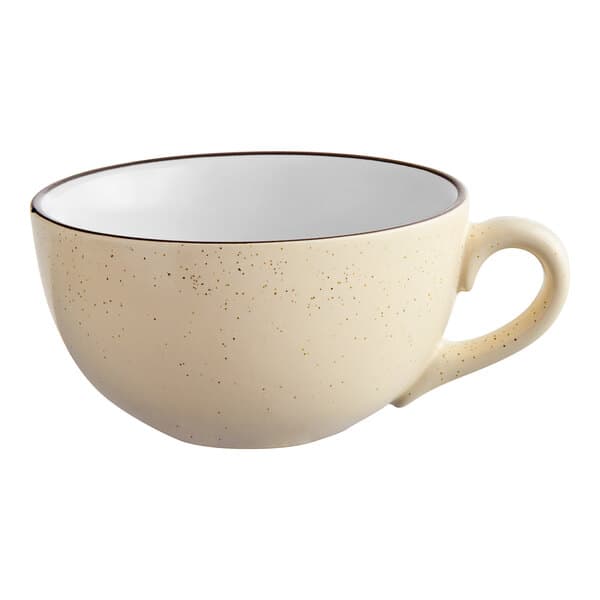 A cream white stoneware cup with a speckled rim.