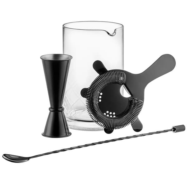 An Acopa black cocktail stirring set with a glass and black bar tools.