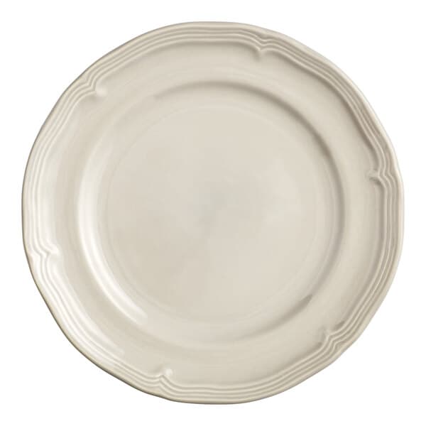 An Acopa Condesa warm gray porcelain plate with a scalloped rim.