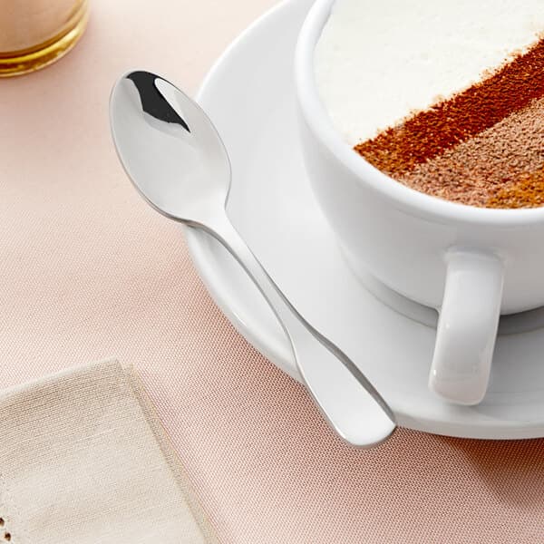 A cup of coffee with an Acopa Triumph stainless steel demitasse spoon on top.