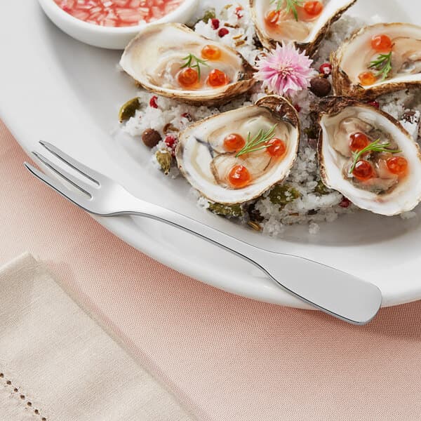 A plate of oysters with a fork.