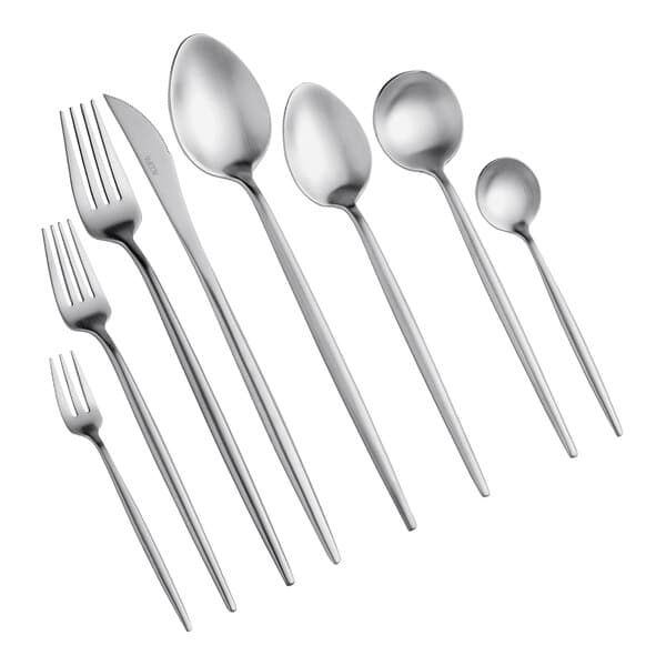 A close-up of several Acopa Odin stainless steel bouillon spoons.