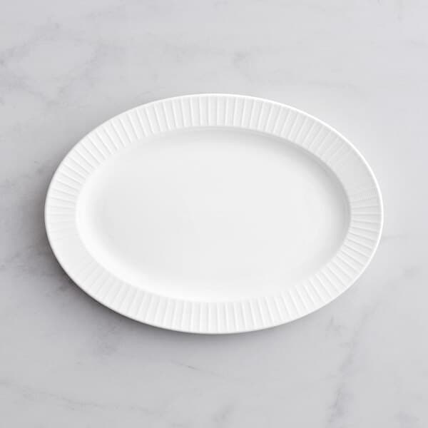An Acopa Cordelia white porcelain platter on a white surface.