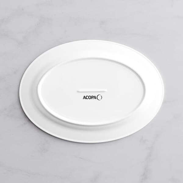 A white oval Acopa porcelain platter with embossed black text on the rim.