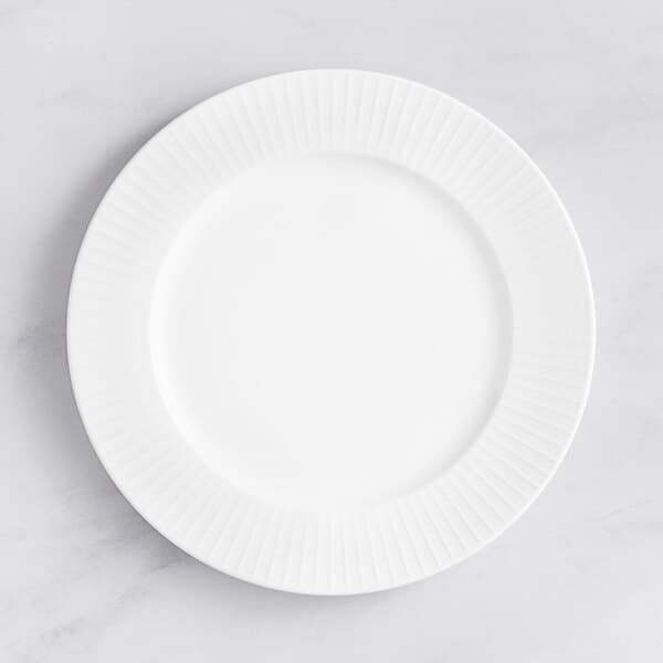 An Acopa Cordelia white porcelain plate with an embossed circular pattern on the rim.