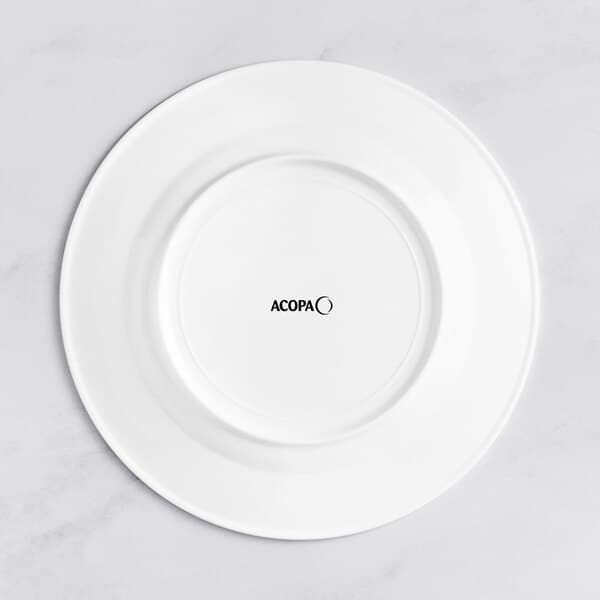 An Acopa Cordelia white porcelain plate with black text on the rim.