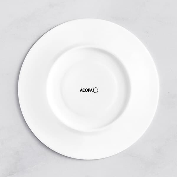 A white Acopa Cordelia saucer with black text reading "moon" in an embossed font.
