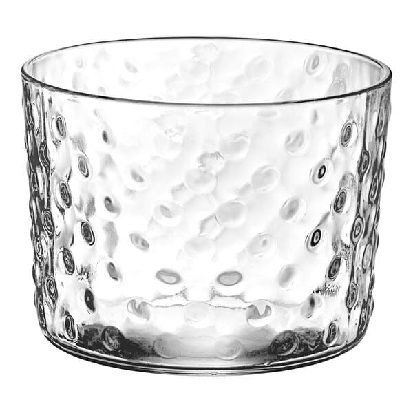 A clear glass cylindrical candle holder with a textured hobnail surface.