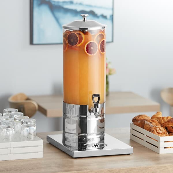 An Acopa stainless steel and polycarbonate beverage dispenser with orange juice.