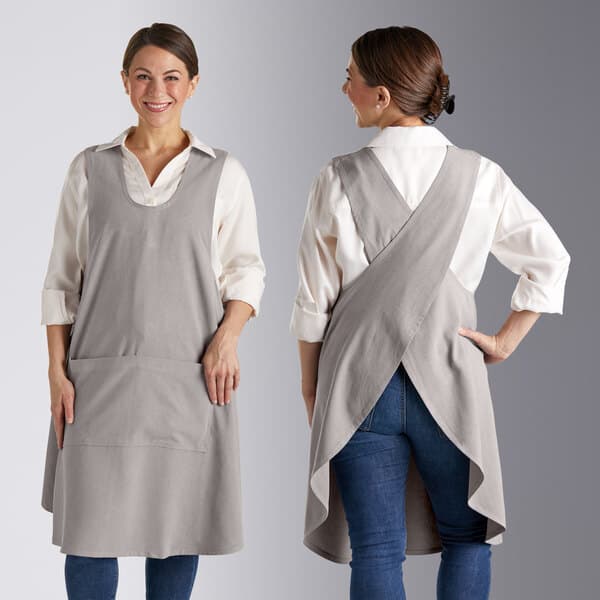 Two women wearing Acopa Ashville smock bib aprons over jeans.