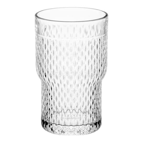 A close-up of an Acopa Rivulet stackable beverage glass with a textured pattern.