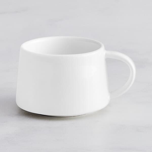 An Acopa Lore bright white porcelain espresso cup with a handle.