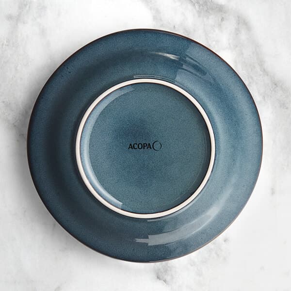 An Acopa Highlands skyfall blue china bowl with a white rim on a table.