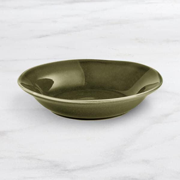 An Acopa Highlands juniper green bowl on a marble surface.