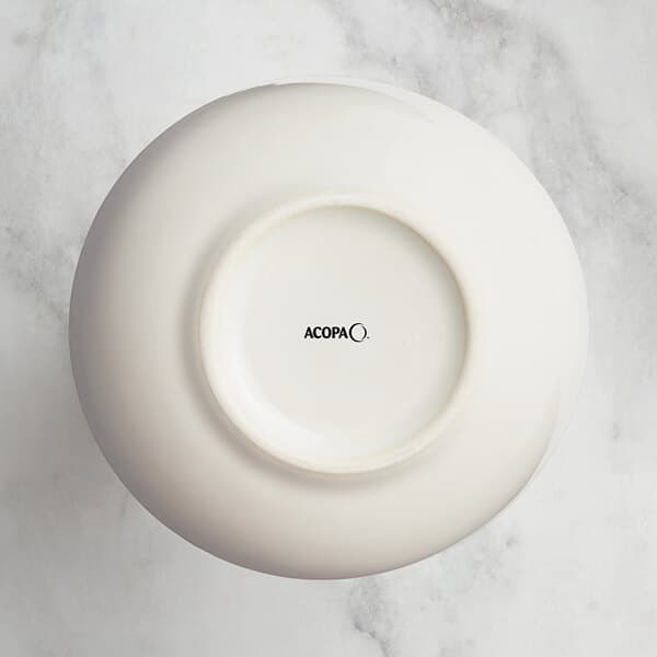 An Acopa white china bouillon cup with black text.