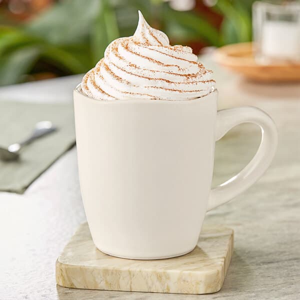 A white Acopa Highlands china mug filled with whipped cream.