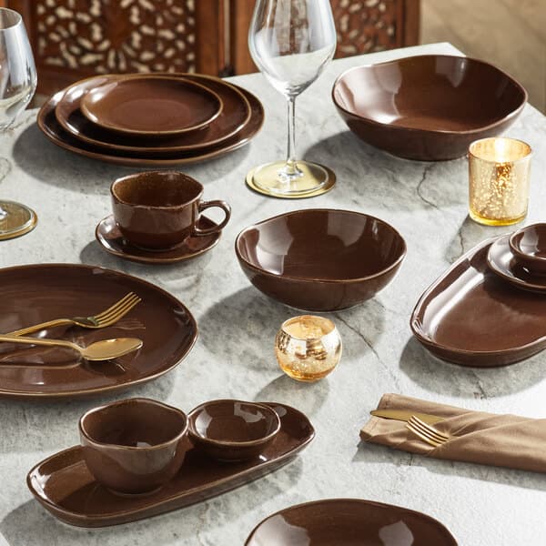 A table set with brown Acopa Highlands china bowls and glasses.