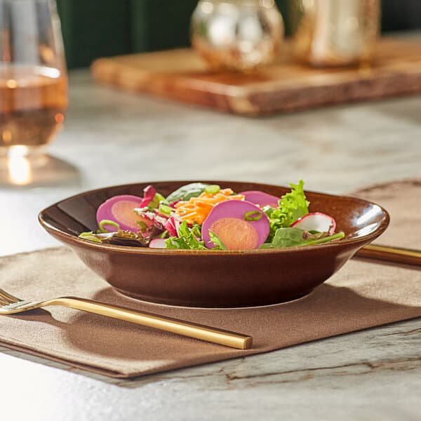 An Acopa Highlands wide rim hazel bowl filled with salad on a table.