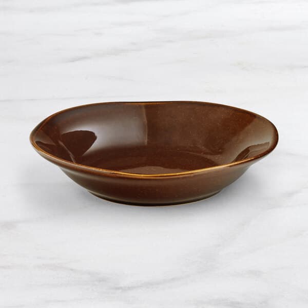 An Acopa Highlands wide rim hazel bowl on a marble surface.