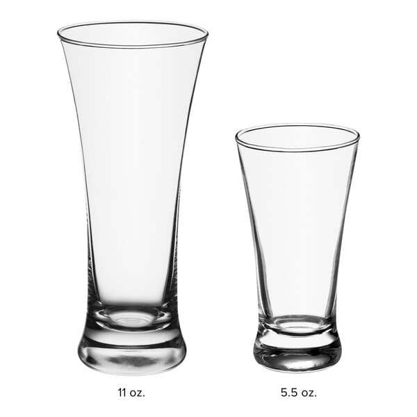 An Acopa flared pilsner glass next to an empty one.