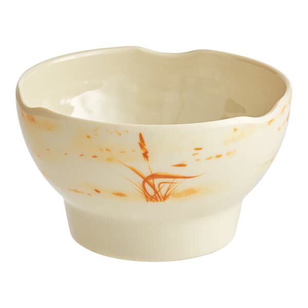 A beige bowl with gold designs.