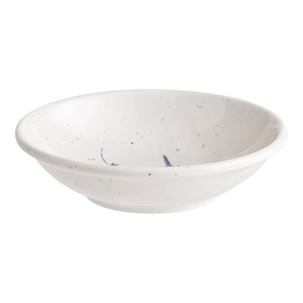 A white round melamine sauce dish with blue speckled spots.