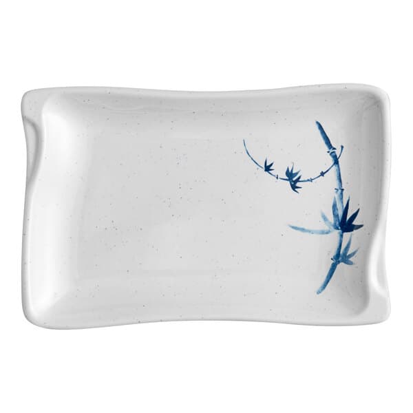 A white and blue speckled plate with blue bamboo design.