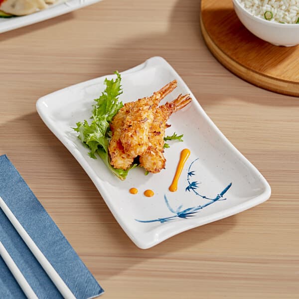 An Acopa Biru rectangular melamine plate with fried shrimp and rice on it.