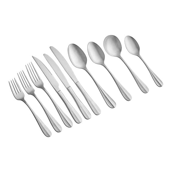 A close-up of Acopa Josette distressed stainless steel table knife with silverware.