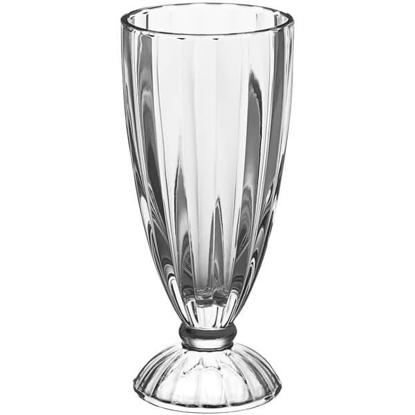 A close-up of an Acopa clear soda glass with a foot.