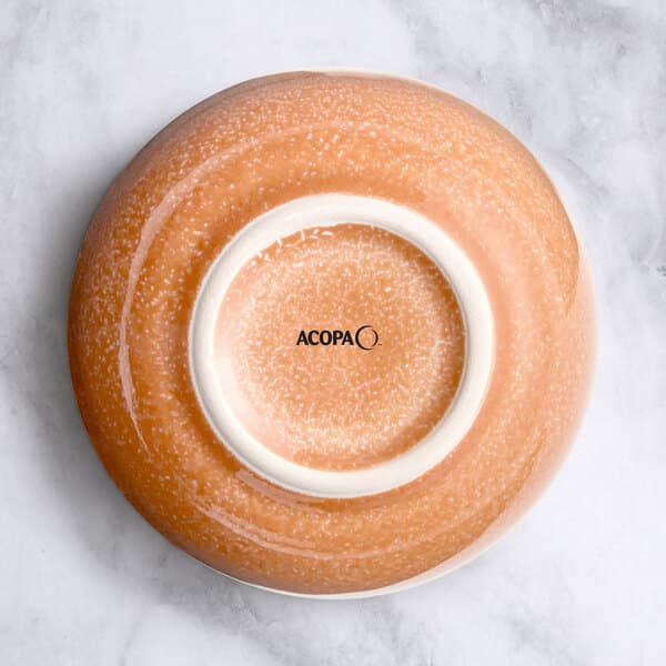 An Acopa Primrose Pink bouillon cup with a white circle in the center.