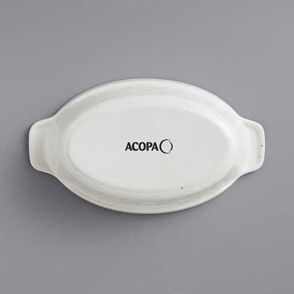 A white oval Acopa porcelain casserole dish.