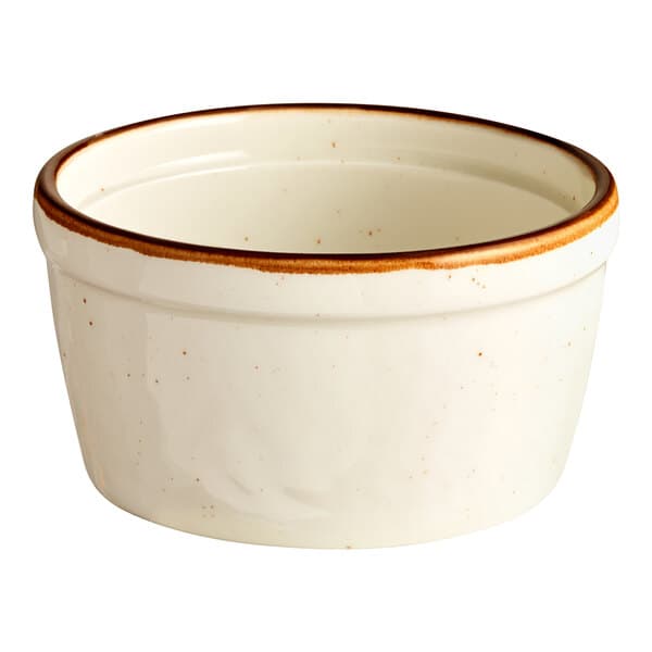 A white porcelain ramekin with a brown rim.