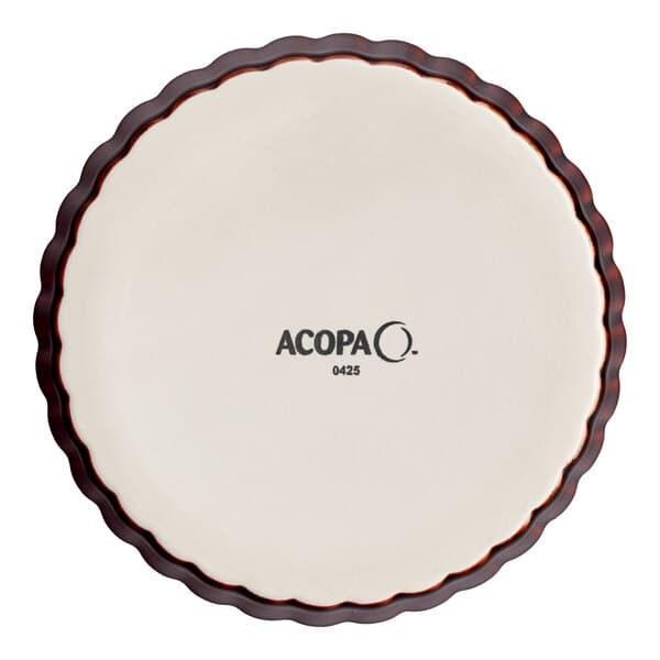 An Acopa Keystone white porcelain souffle dish with a brown edge.