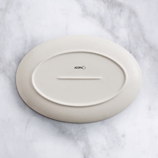 An Acopa beige porcelain oval platter on a white background.