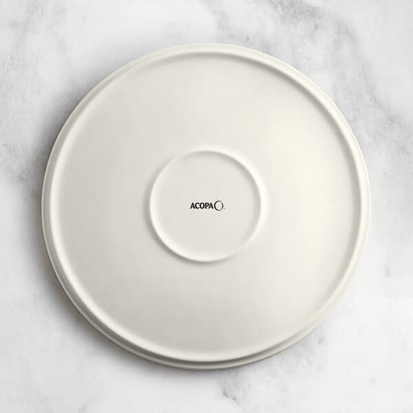 An Acopa Cape beige porcelain plate with black text that says "Oma" on it.