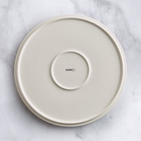 An Acopa Cape beige porcelain plate with a circular design on it.