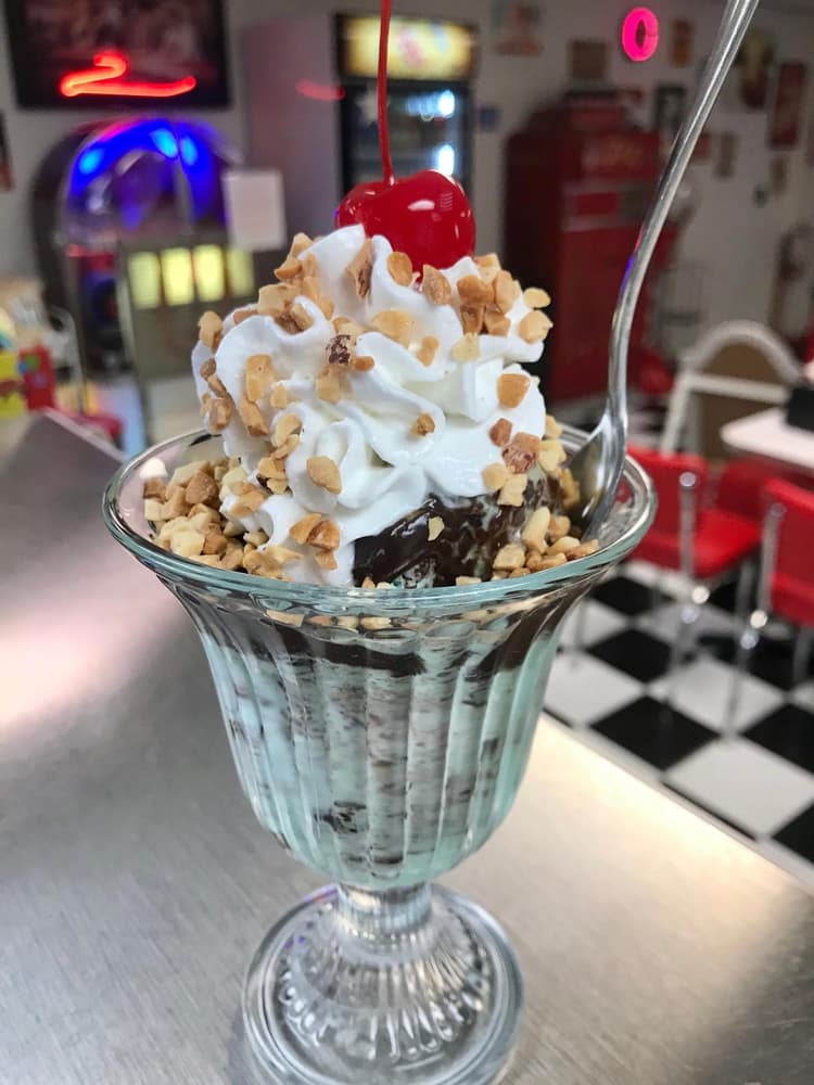 Acopa 6” spoon in a hot fudge sundae.