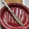Picture of the Acopa Edgewood / Edgeworth 8 1/2" 18/8 Stainless Steel Extra Heavy Weight Dinner Knife in a plate.