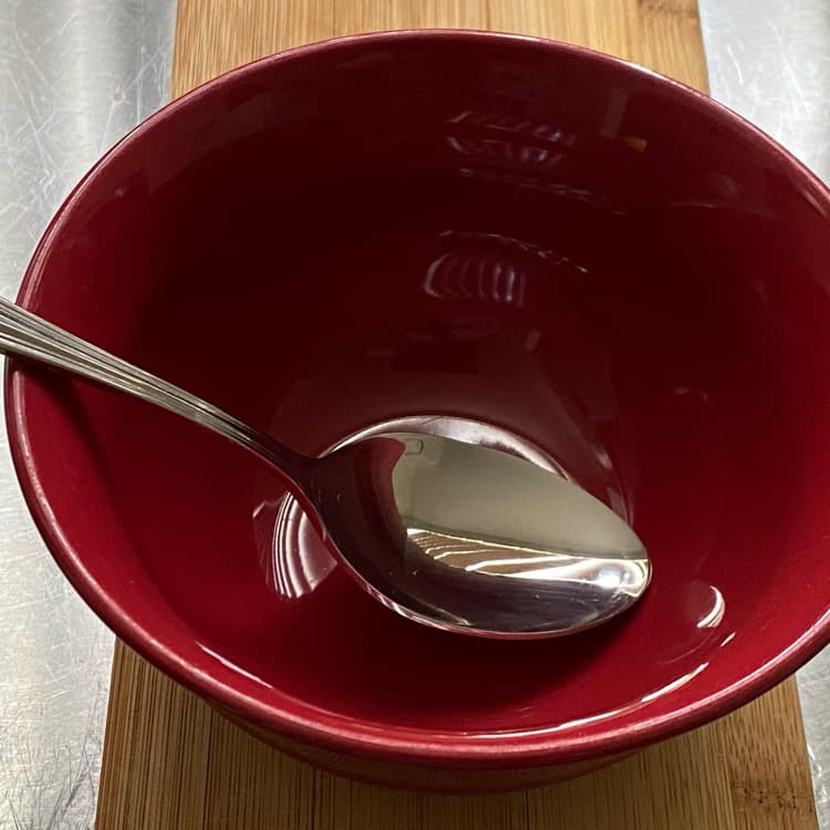 Photo of Acopa Edgeworth 7 3/4" 18/8 Stainless Steel Extra Heavy Weight Tablespoon / Serving Spoon in a bowl.