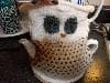 Teapot wearing its cute owl cozy.