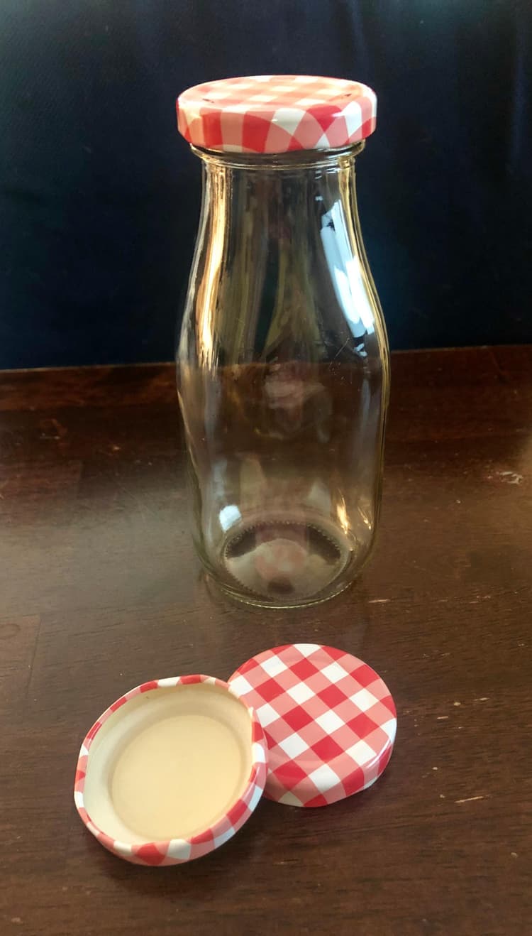 Acopa red plaid milk bottle lids.