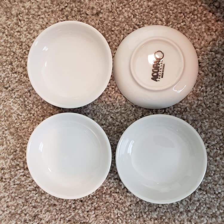 Here are 4 dishes side by side. They have a nice glossy smooth finish on them. The bottom does, however, have this stamped onto it.