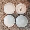 Here are 4 dishes side by side. They have a nice glossy smooth finish on them. The bottom does, however, have this stamped onto it.